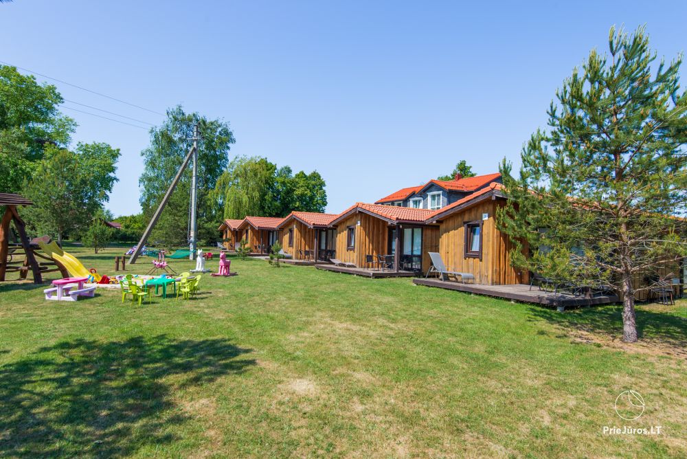 Fetingas - wooden houses and guest house on the river bank