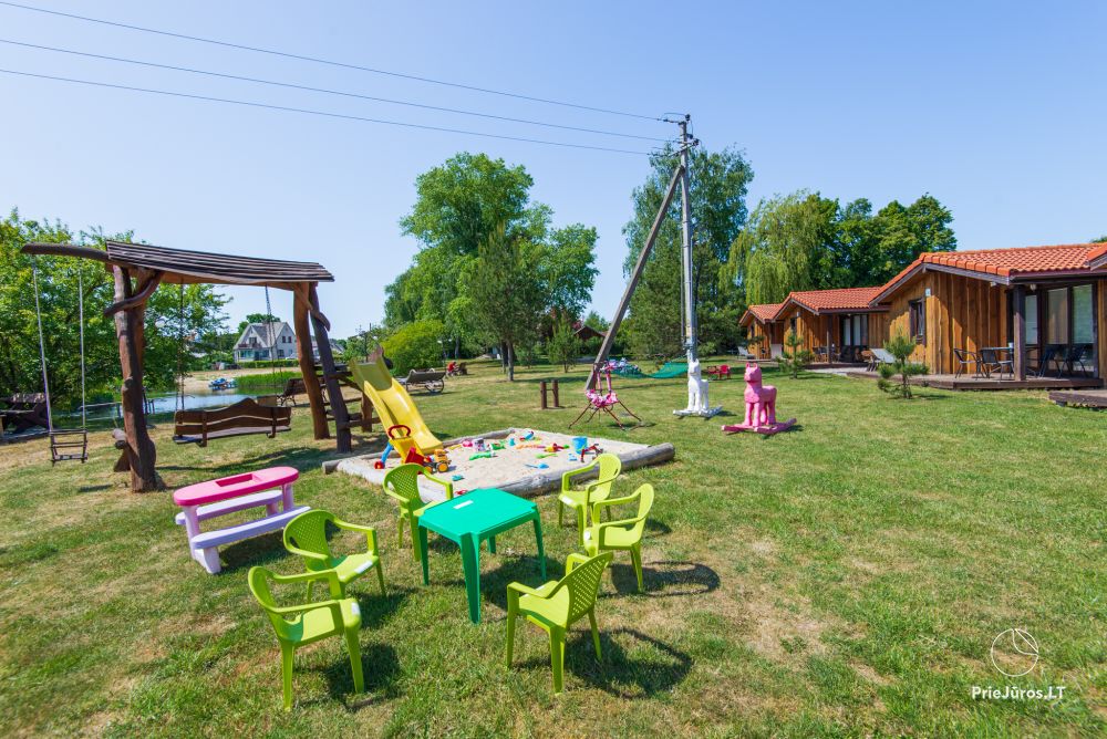 Fetingas - wooden houses and guest house on the river bank