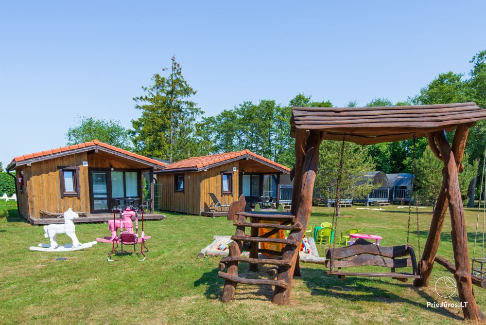 Fetingas - wooden houses and guest house on the river bank