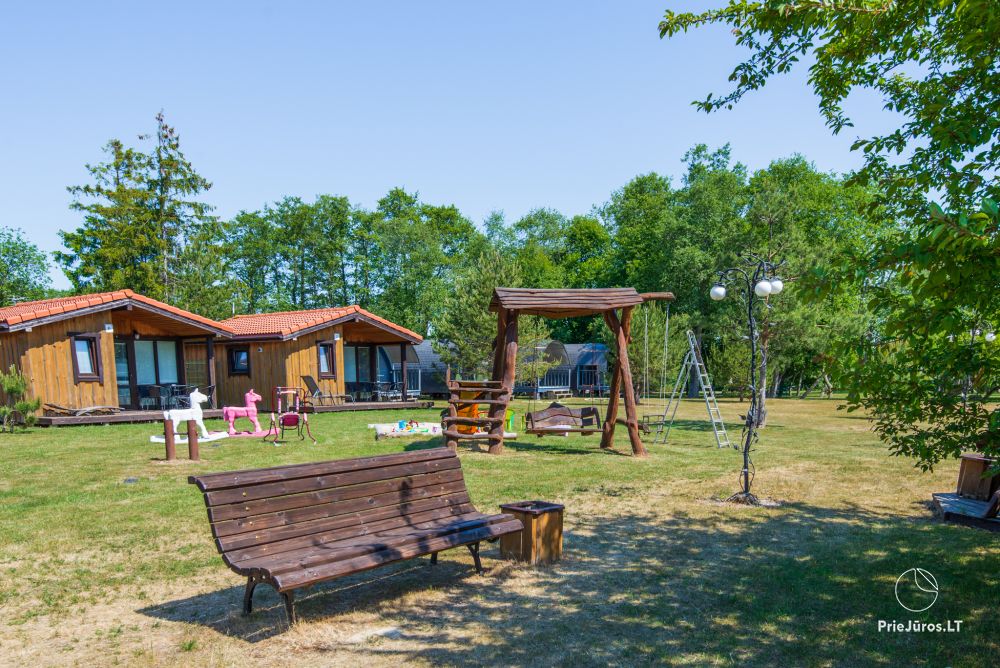 Fetingas - wooden houses and guest house on the river bank