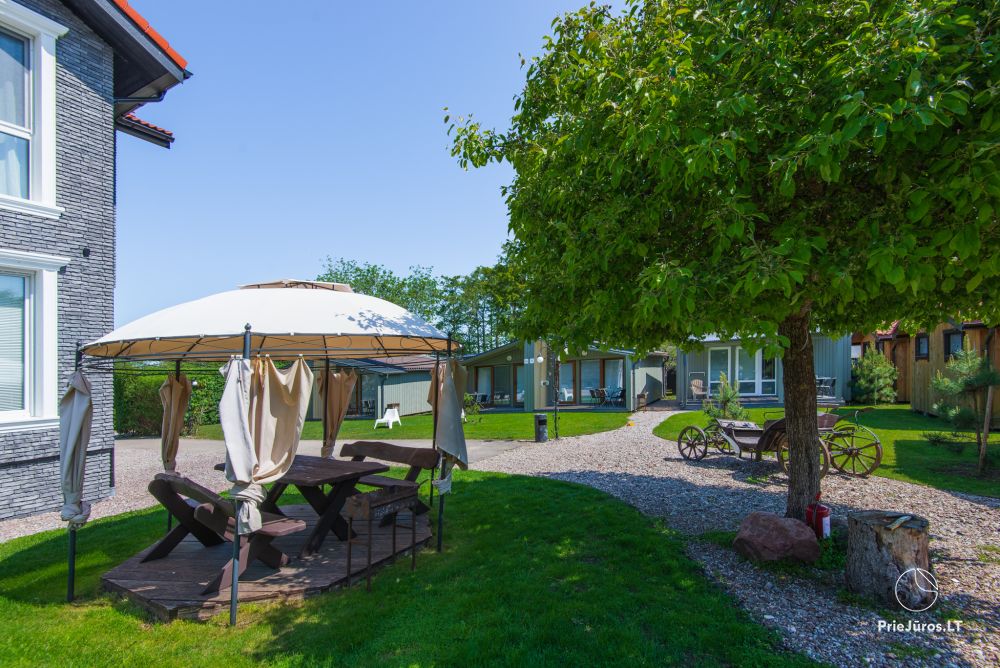 Fetingas - wooden houses and guest house on the river bank