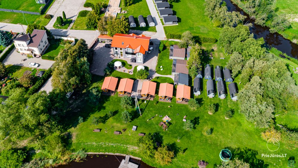 Fetingas - wooden houses and guest house on the river bank