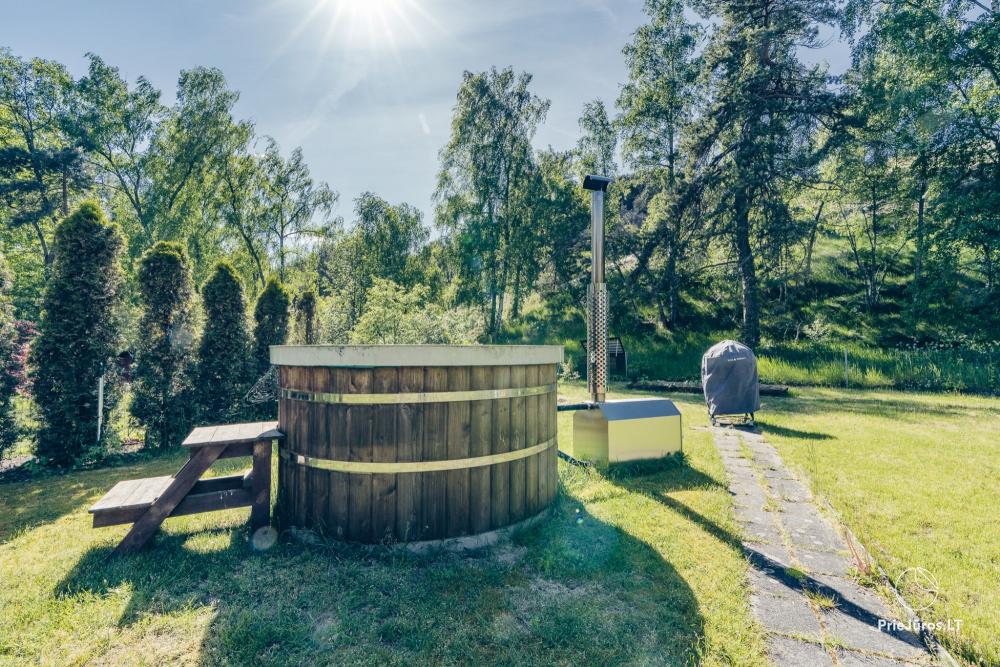 Two apartments with a yard and a hot tub in Preila