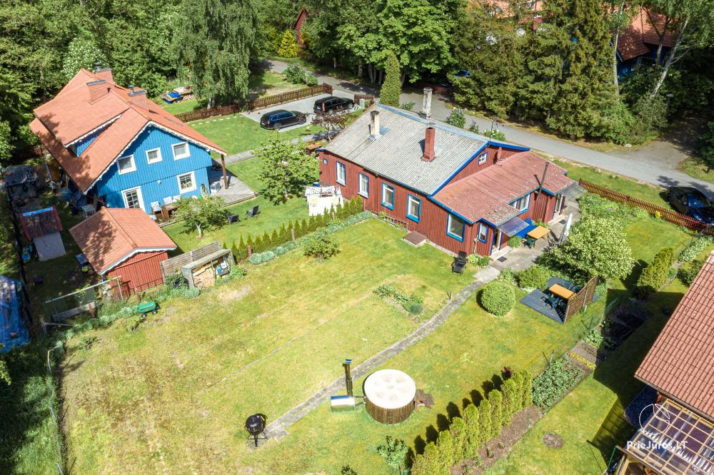 Two apartments with a yard and a hot tub in Preila