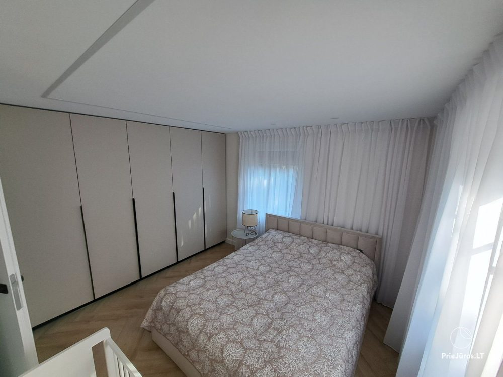 Stylish apartment with a private yard and a cozy house overlooking the lagoon for rent in Preila